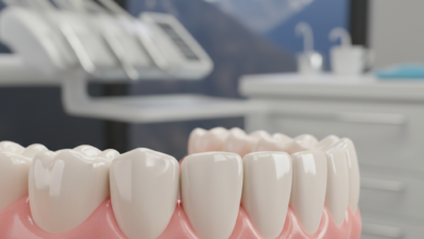 Close-up image of a perfectly contoured, healthy gum line around bright, clean teeth. The background is a soft blur of a modern dental clinic interior with a distant, out-of-focus mountain view.