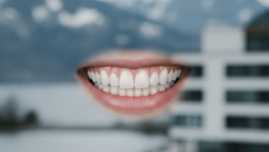 Close-up of a bright, healthy, and perfectly restored natural smile with impeccably aligned teeth, against a very softly blurred background hinting at a pristine Swiss Alpine landscape and modern architectural elements.
