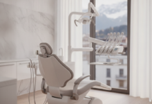 A pristine and modern dental examination room with a comfortable, high-tech dental chair. Advanced, minimalist dental equipment is subtly visible in the background, and a blurred view through a window shows an elegant cityscape with distant mountains, suggesting Switzerland. The scene conveys professionalism and comfort.