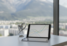 A photorealistic image of a modern, minimalist desk. On the desk, a tablet displays abstract financial graphs without text. A subtle, abstract tooth shape is nearby. Through a blurred window in the background, a beautiful Swiss Alpine landscape is visible, symbolizing dental insurance planning in Switzerland.