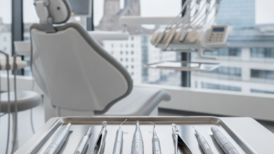 A close-up of sterile, gleaming dental instruments on a tray in a modern clinic, with a blurred background hinting at the city of Basel, Switzerland.